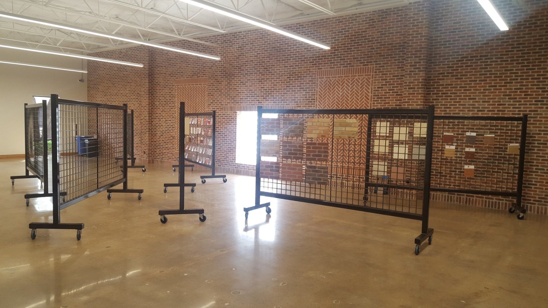 A large room with a lot of clothes racks in it.