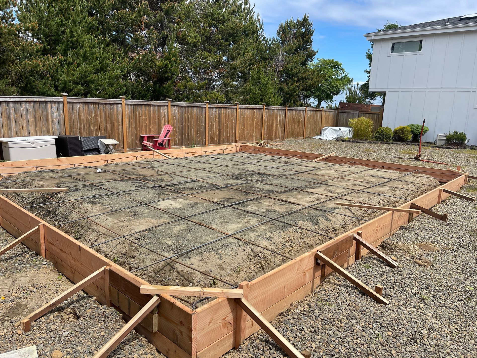 A house is being built on top of a dirt hill.