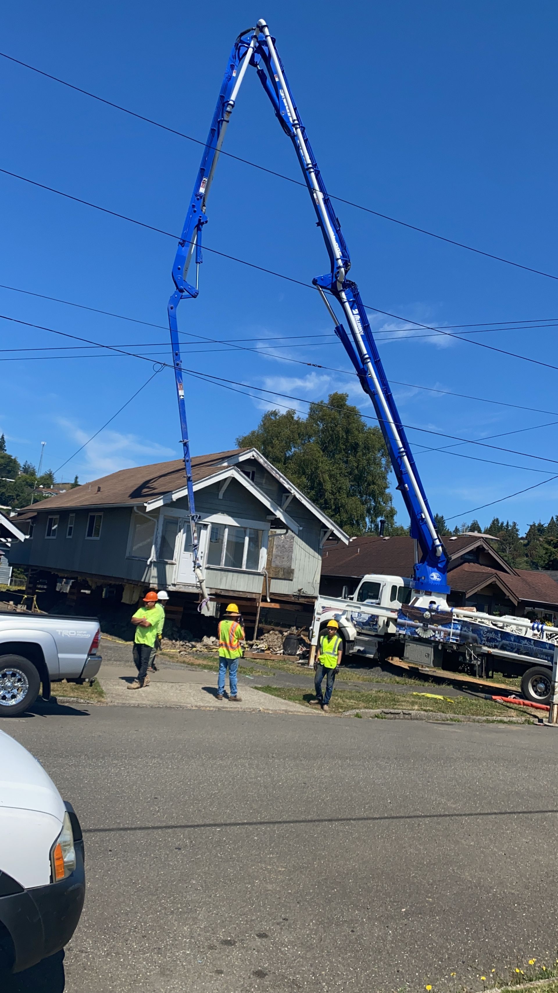 A house is being demolished by a bulldozer.