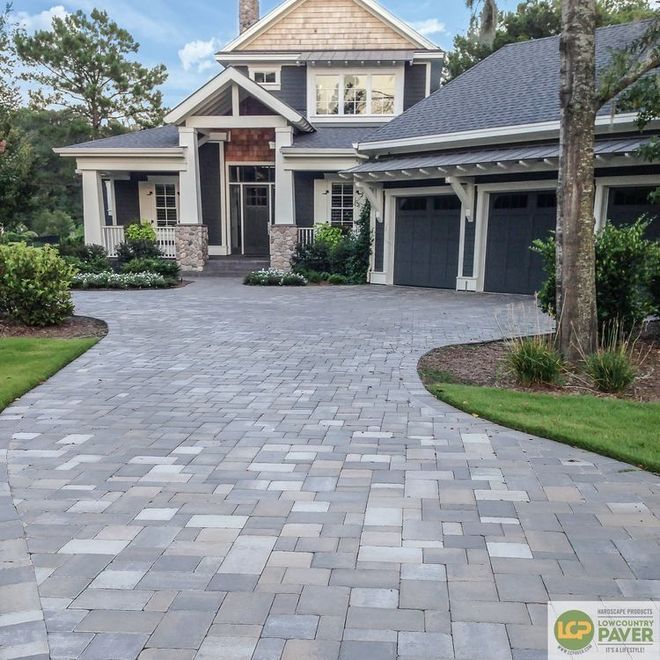 A large house with a brick driveway leading to it