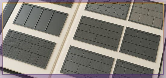 Assorted gray and black rectangular roof shingle samples arranged in a grid on a white surface