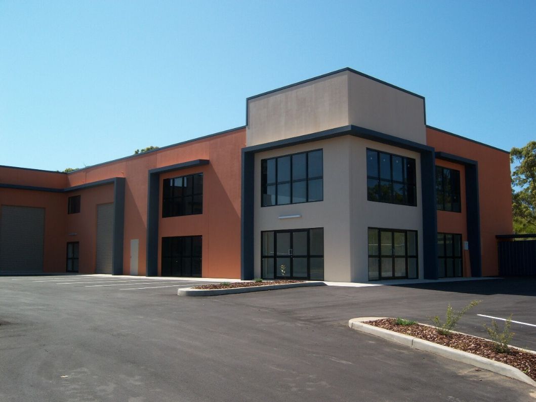 A Large Orange And White Building With A Lot Of Windows — Certcorp DGL in Bundaberg South, QLD