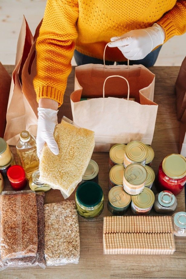 A Person Is Holding A Bag Of Food On A Table