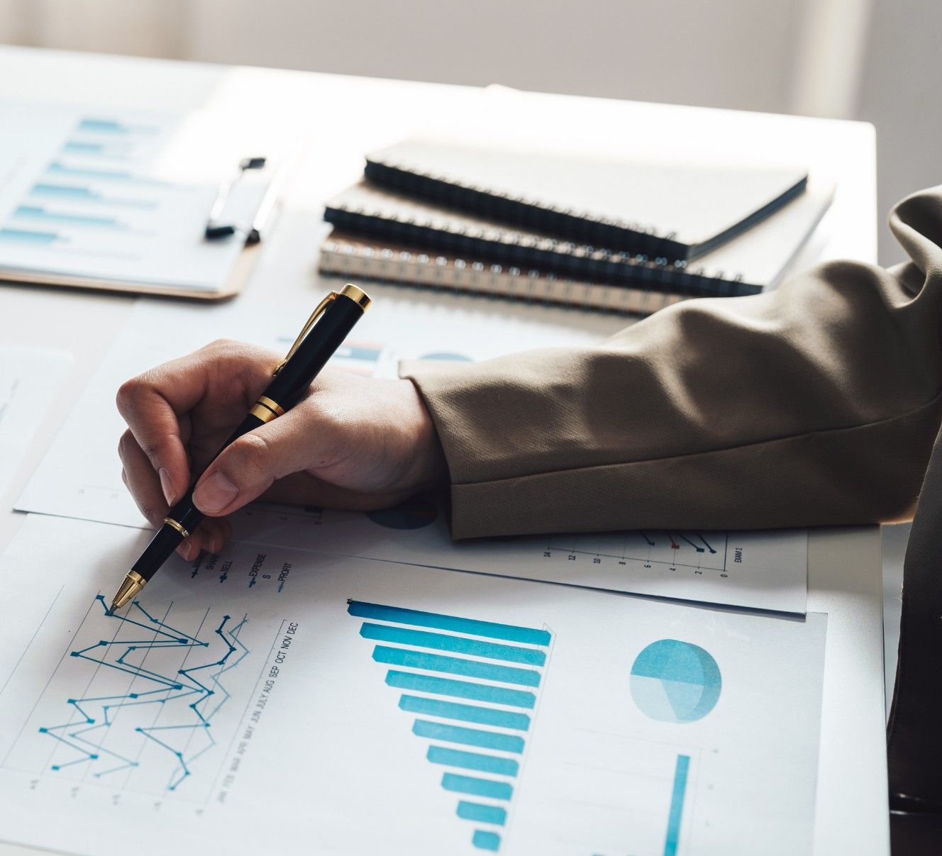 A Person Is Writing On A Piece Of Paper With A Pen