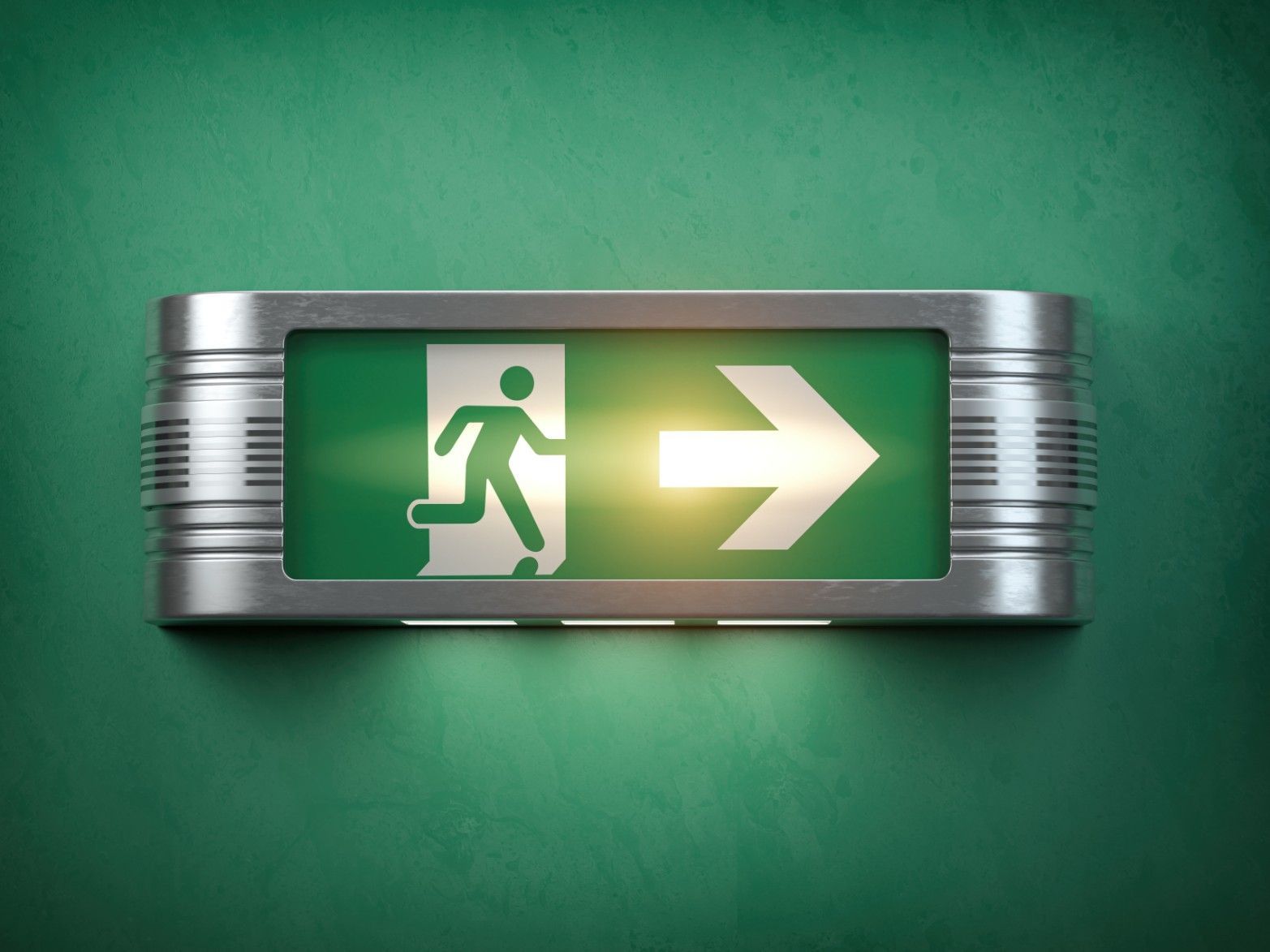 A Green Exit Sign With a Man Running and an Arrow Pointing to the Right