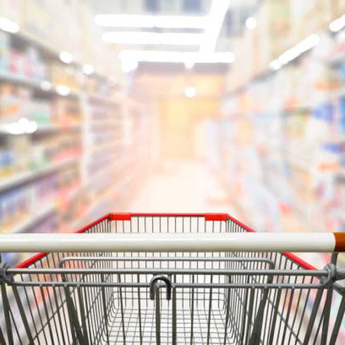 Supermarket aisle with stocked shelves representing FMCG supply chain and inventory management success