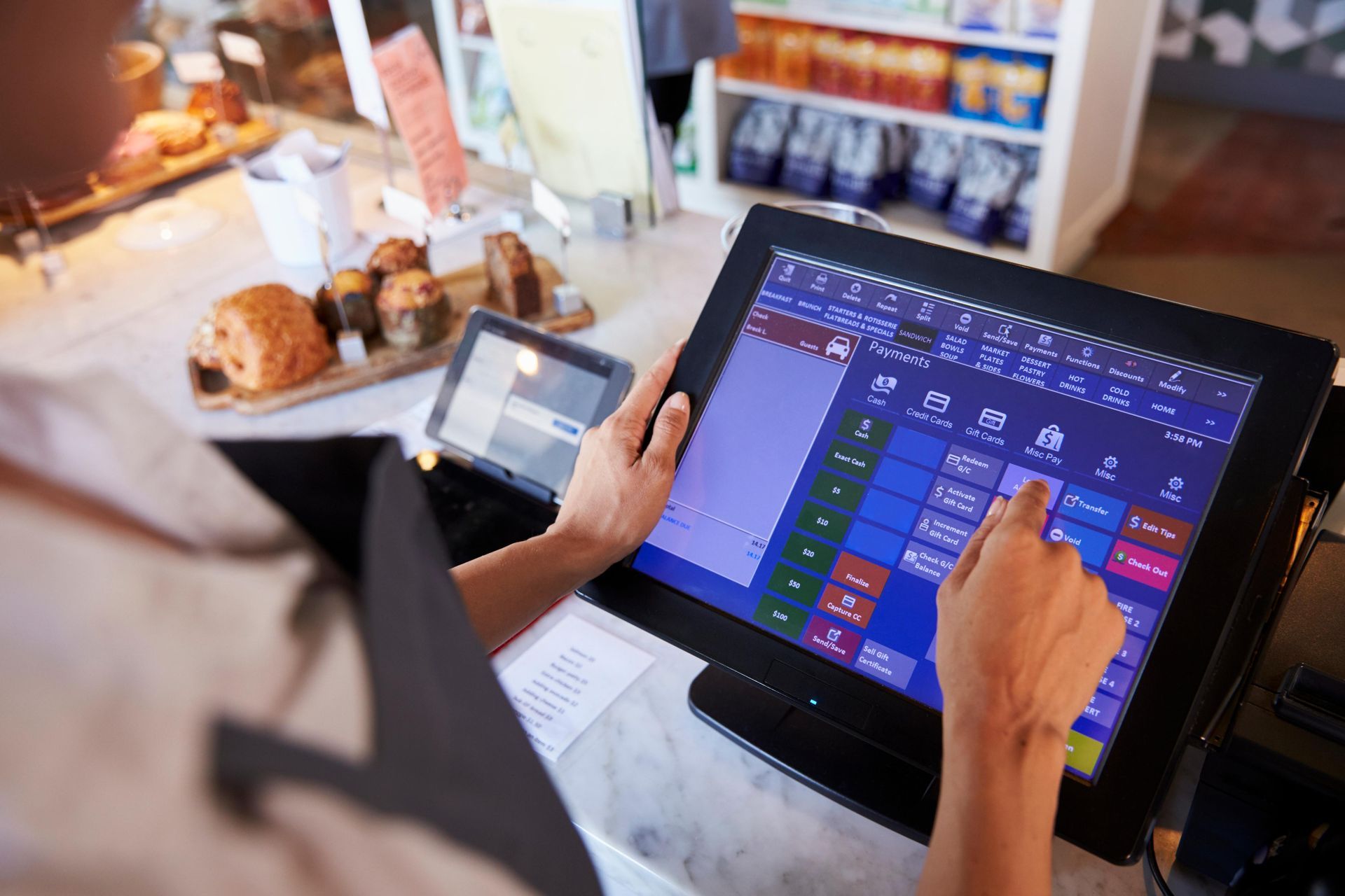 A Person Is Using A Tablet Computer In A Restaurant.