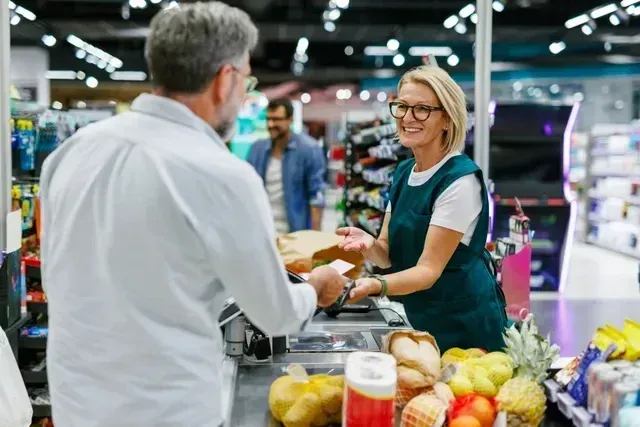 Retail consultants discussing products in supermarket representing end-to-end FMCG services