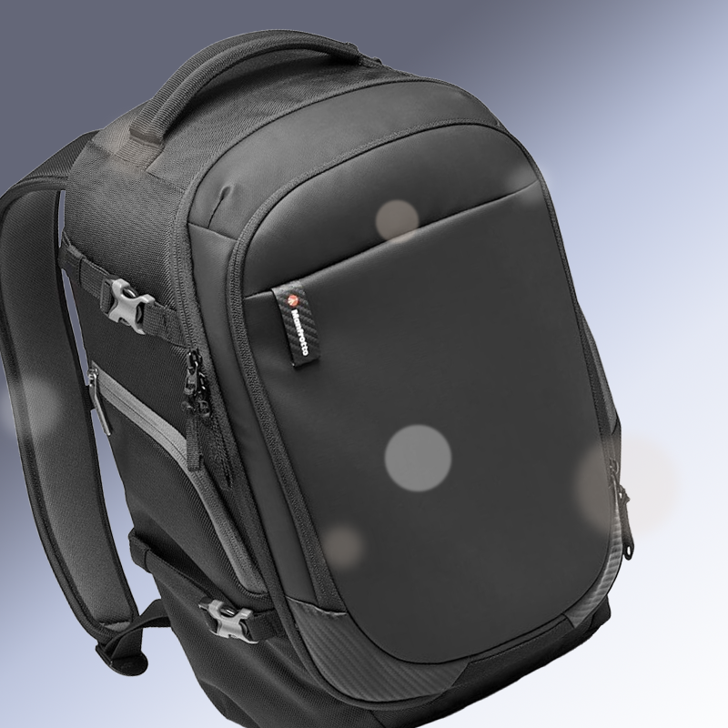Black backpack with padded front pocket and side zippers on a light background
