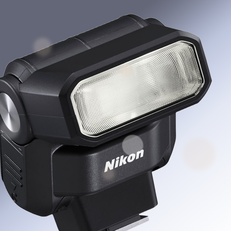 Black Nikon camera flash unit with a clear rectangular diffuser on a light gray background