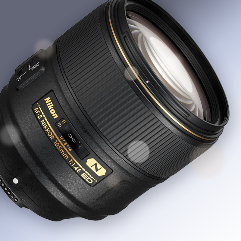 Black Nikon camera lens on a light gray background