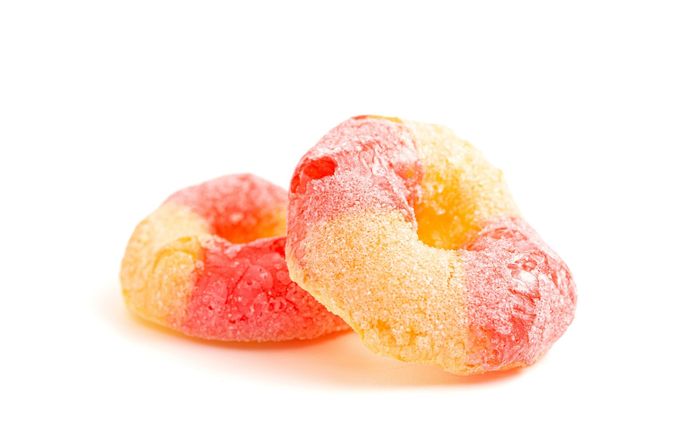 A close up of two cereal rings on a white background.
