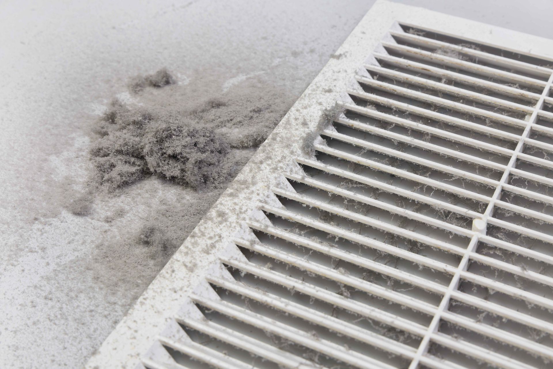 a close up of a dirty air vent with dust on it