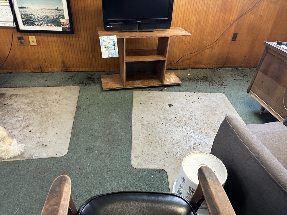 A living room with a tv on a wooden stand