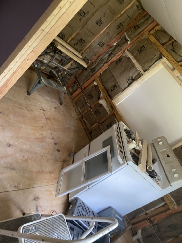 A kitchen with a stove and a microwave in it