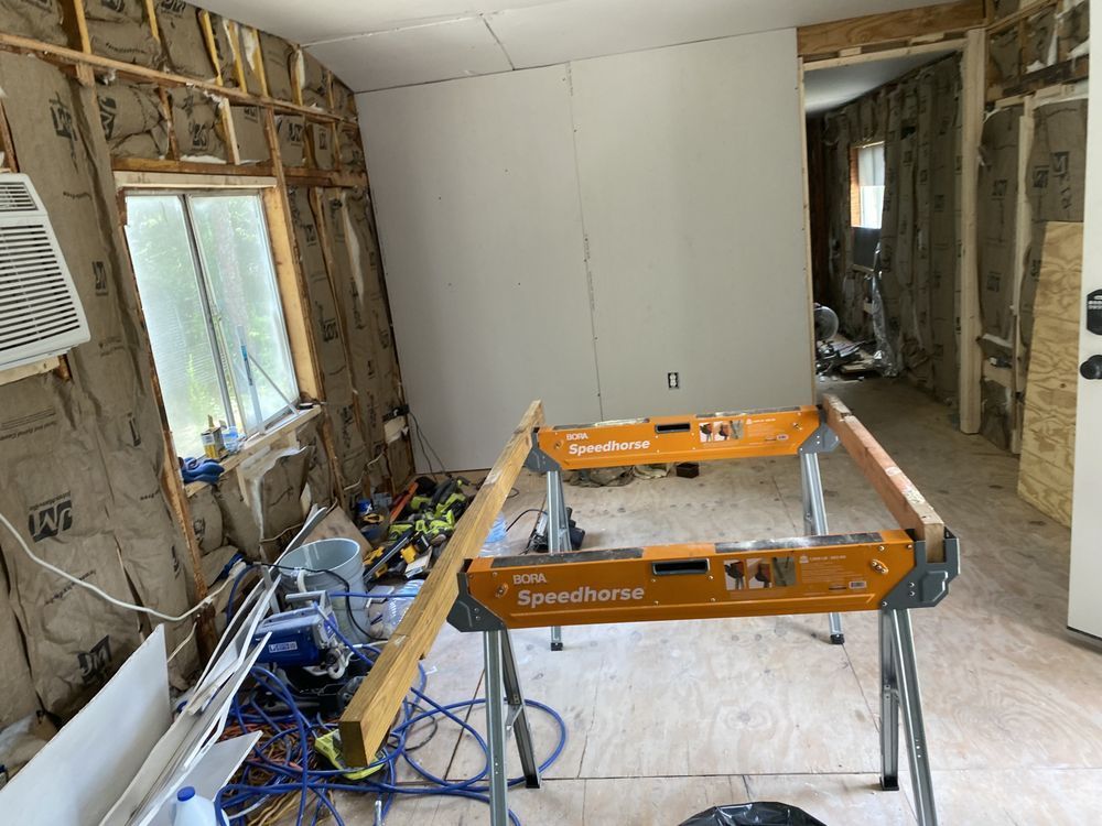 a room under construction with a saw on a workbench