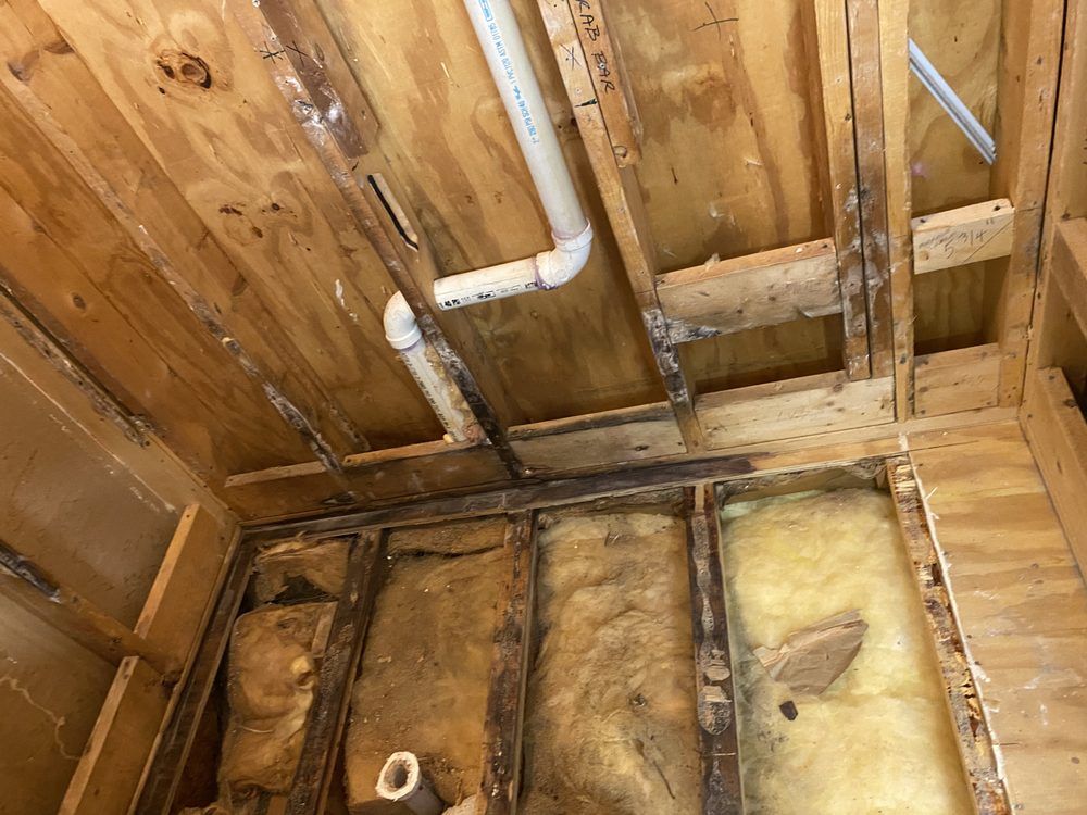 a bathroom under construction with a pipe coming out of the ceiling