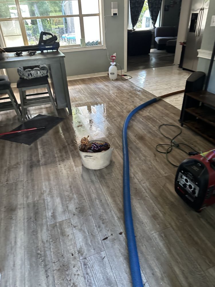 a vacuum cleaner is sitting on a wooden floor in a living room