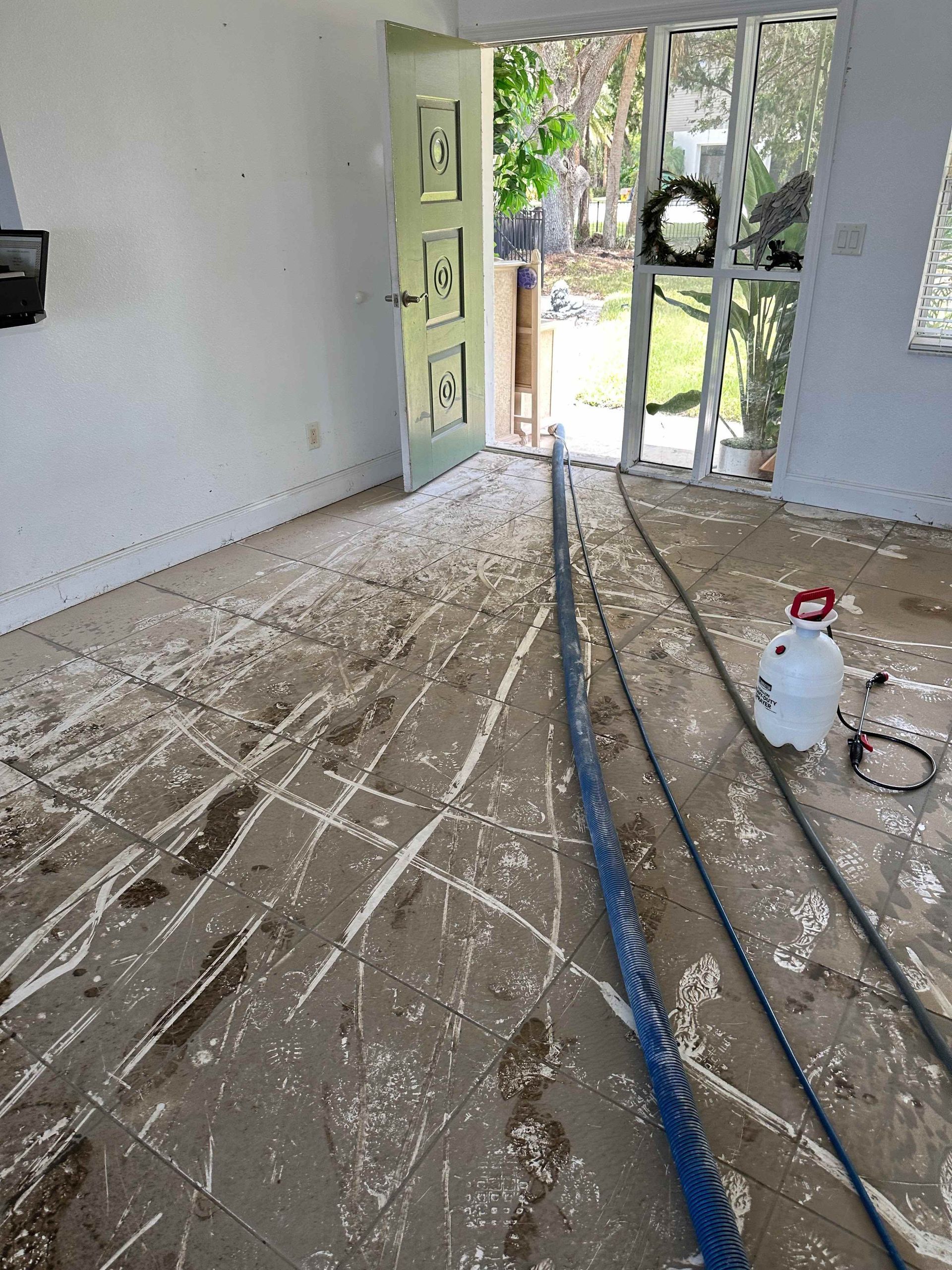 a room with a vacuum cleaner and a hose on the floor