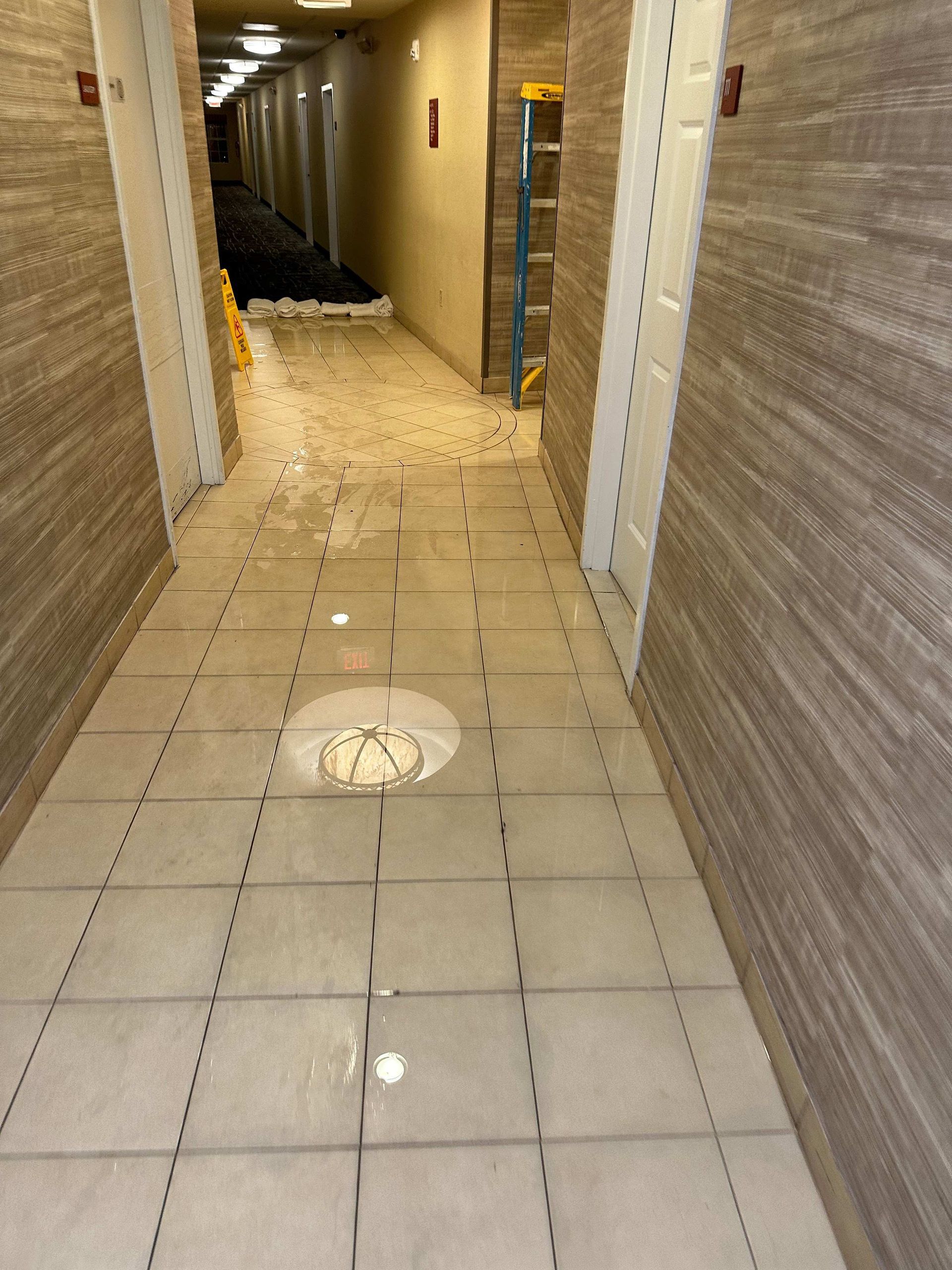 a hallway with a large puddle in the middle of it