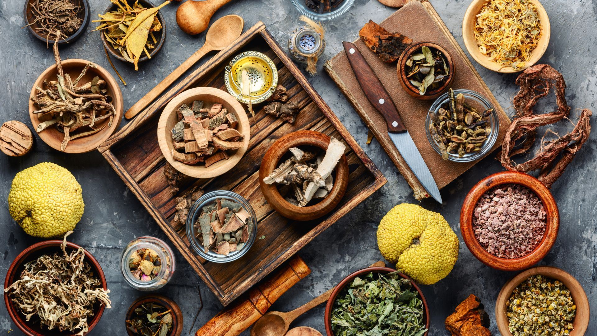 There are many different types of herbs and spices on the table.