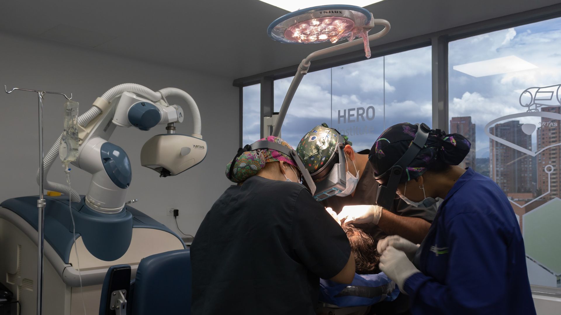 A group of surgeons are operating on a patient in an operating room.