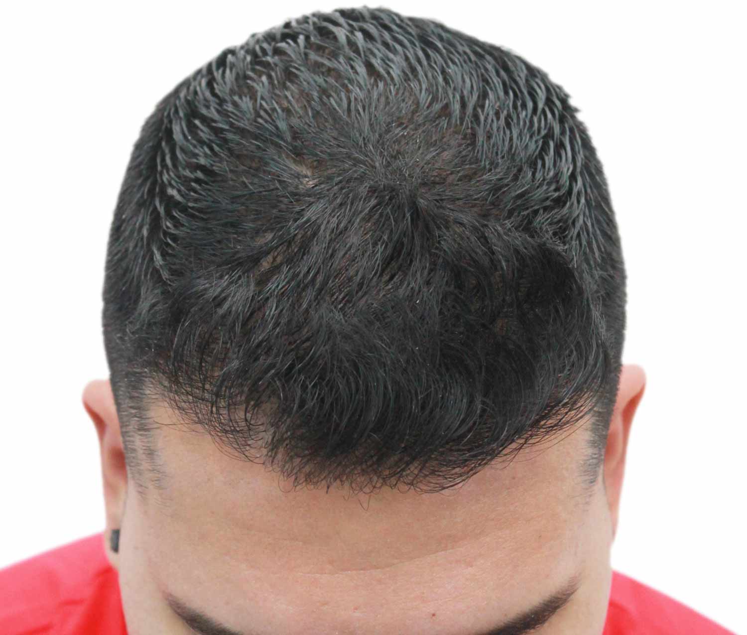a close up of a man 's head with a red shirt on