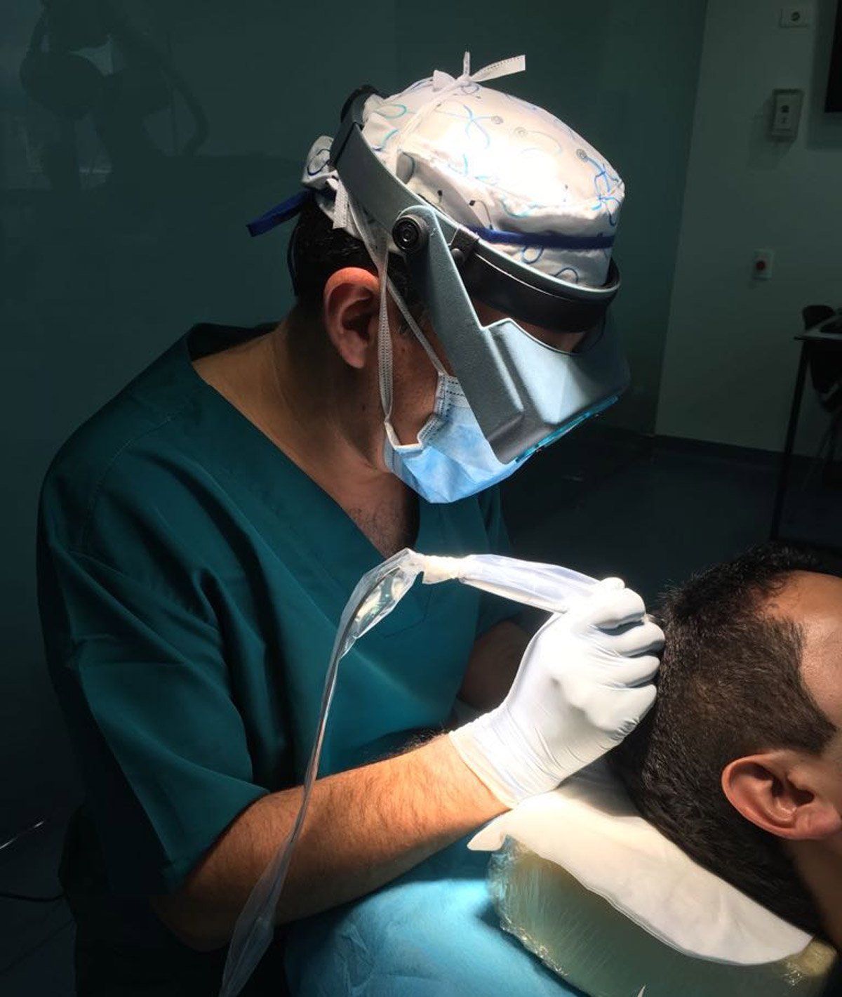 a surgeon wearing a mask and gloves is working on a patient 's head