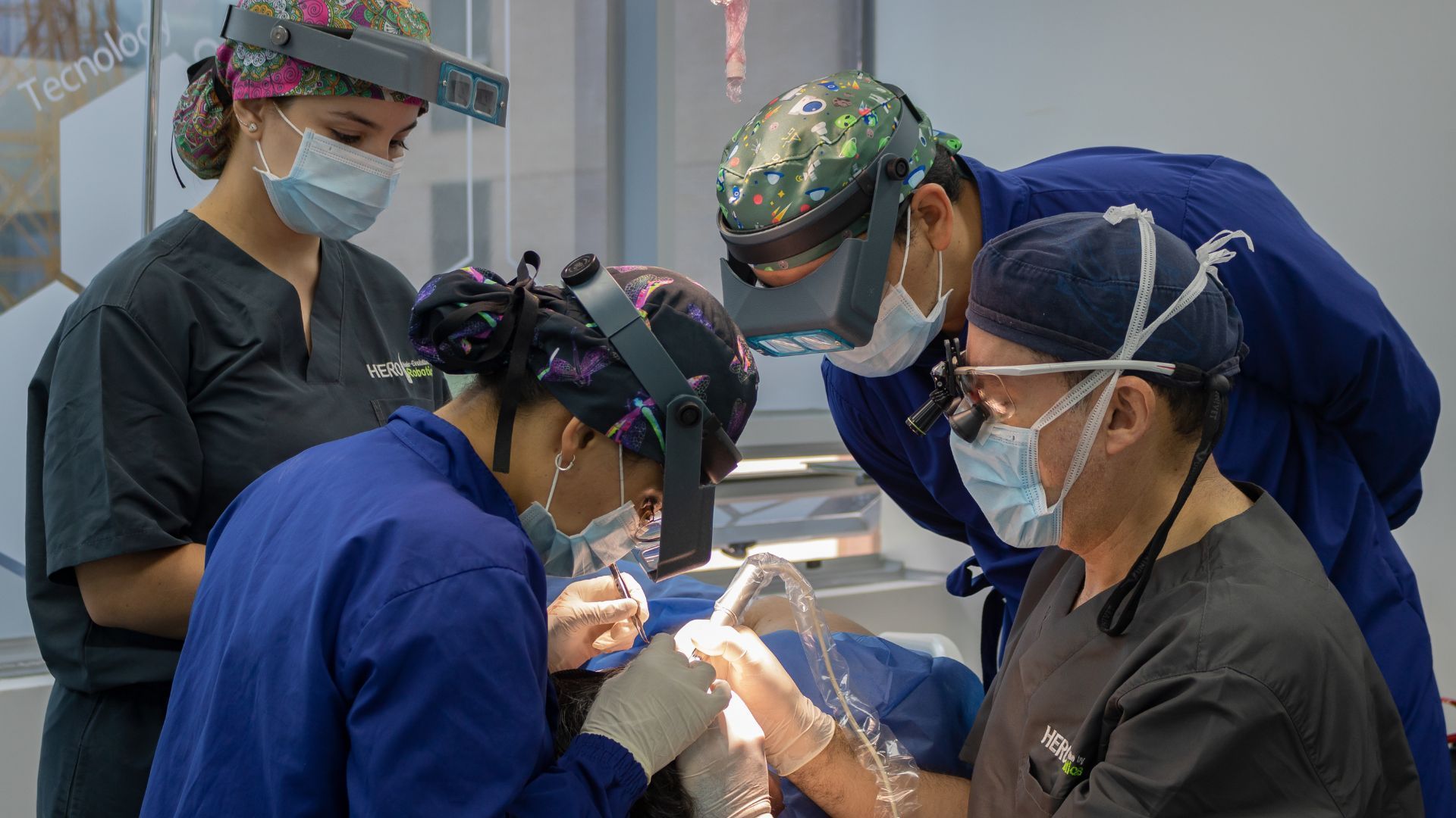 A group of surgeons are working on a patient in a hospital.