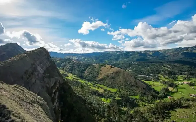A view of a mountain valley from the top of a mountain.