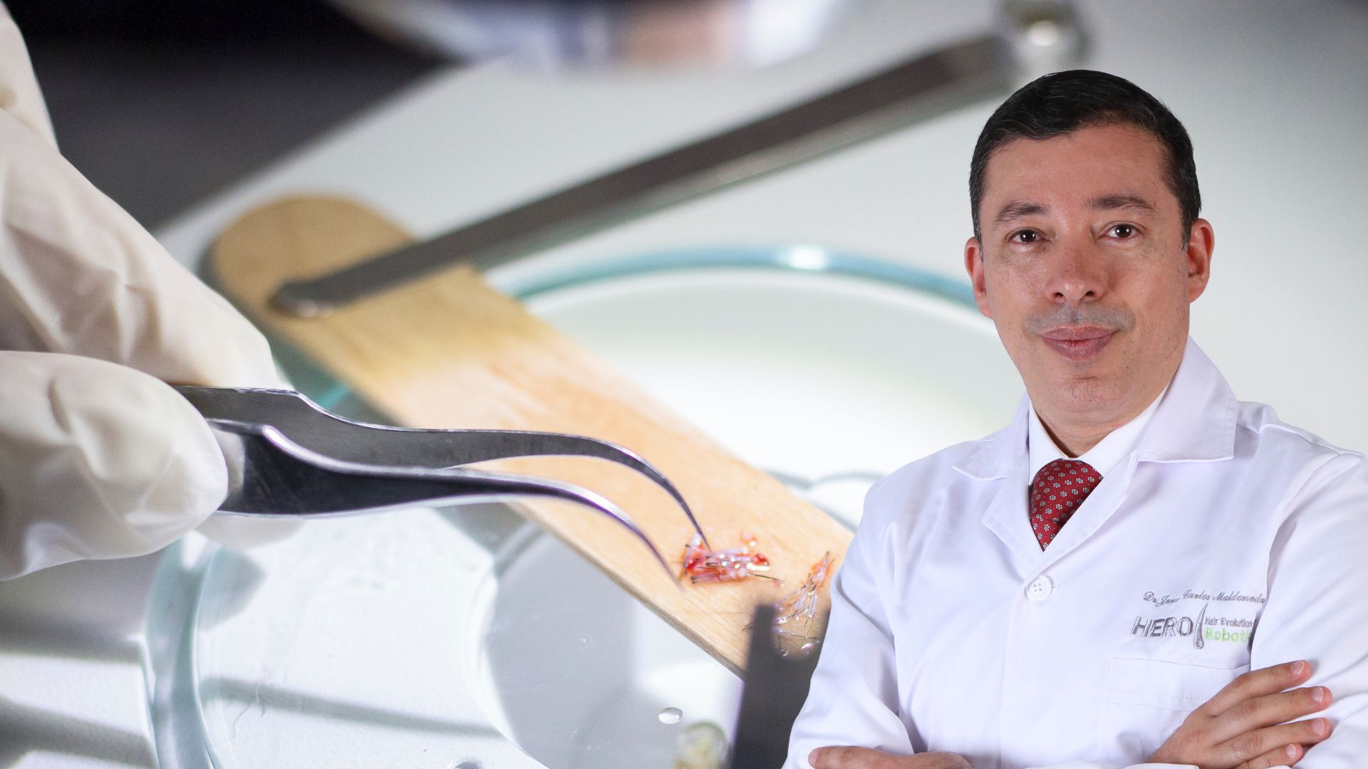 A doctor in a lab coat is near a petri dish and a wooden spatula, with forceps holding tissue.