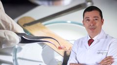 Doctor Maldonado in lab coat with medical tools; sample on wood; close-up.