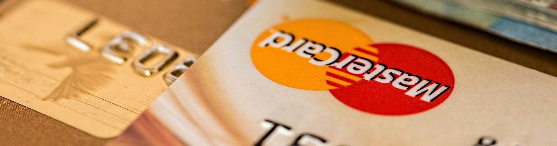 A close up of a mastercard credit card on a table.
