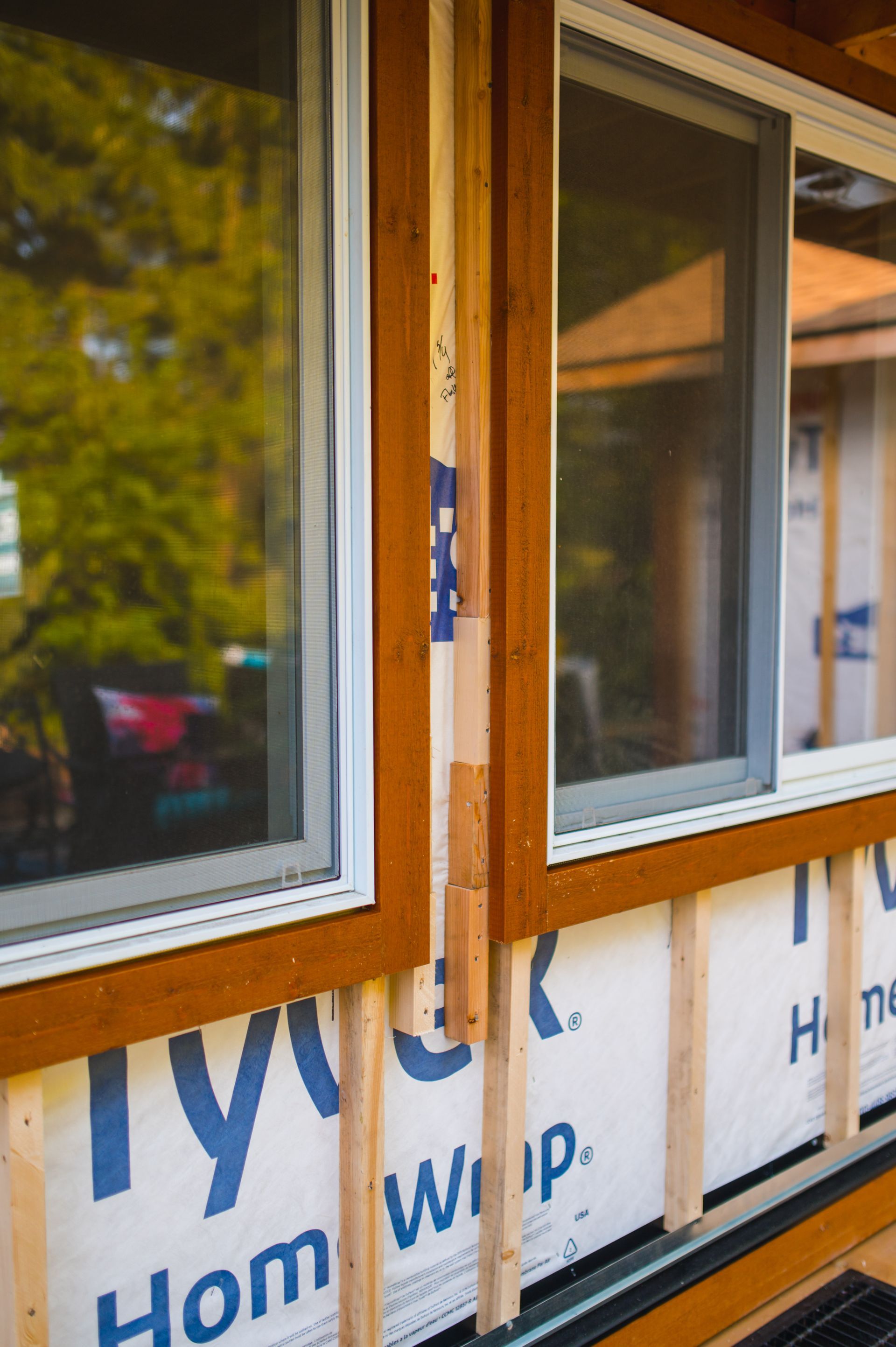A house with a lot of windows is being built.