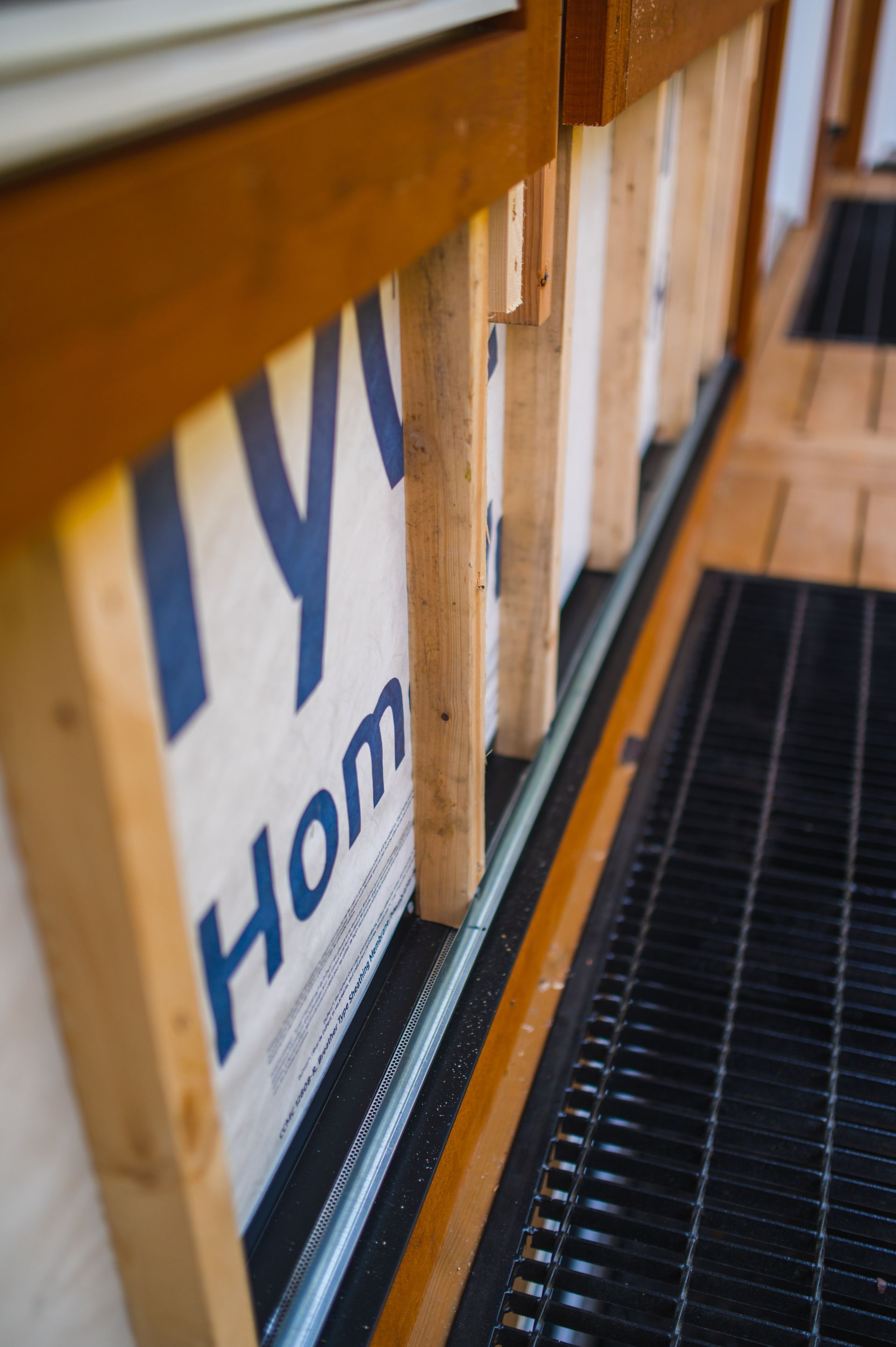 A wooden wall with a sign that says home on it