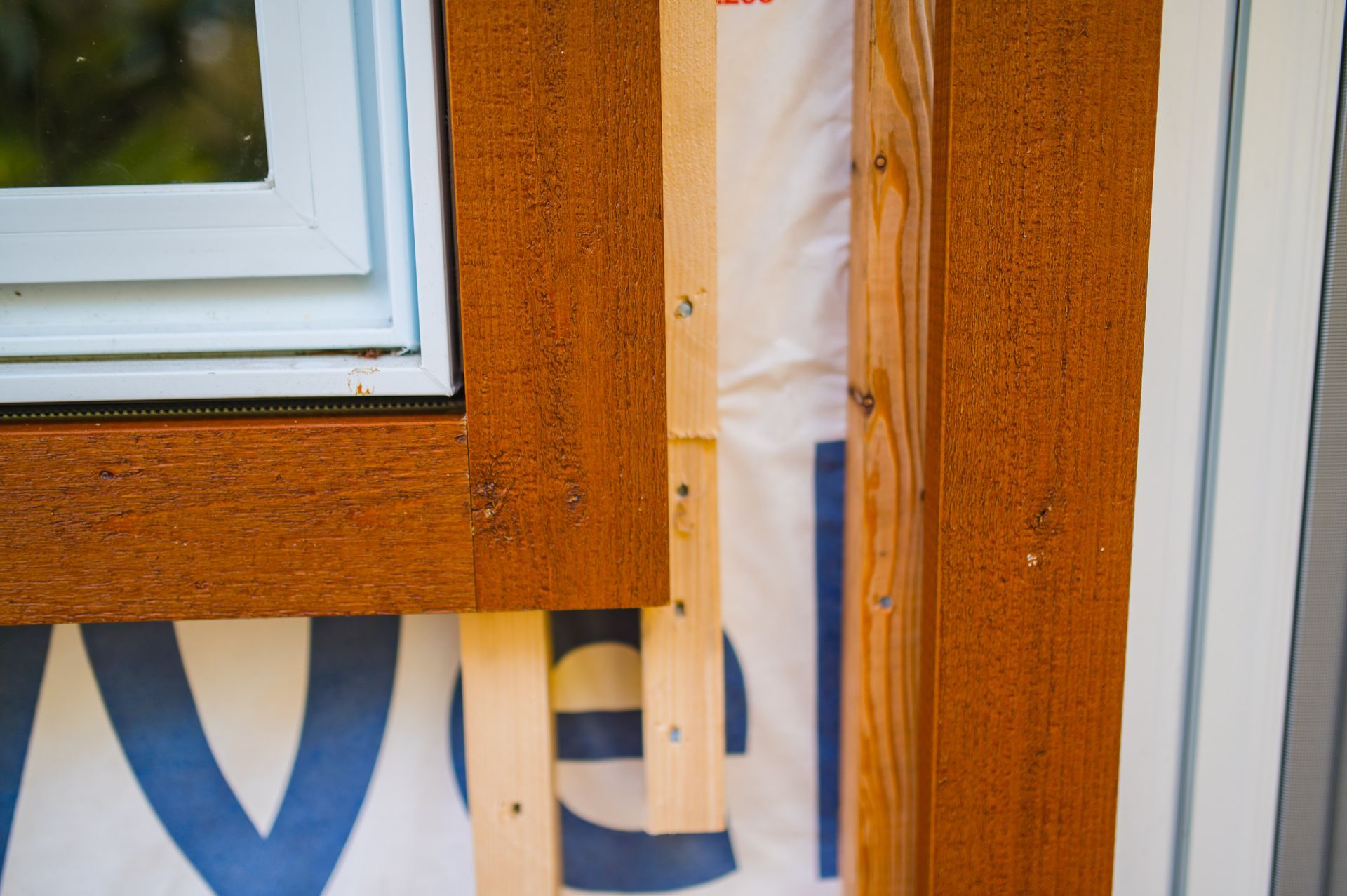 A window is being built into a wooden wall.