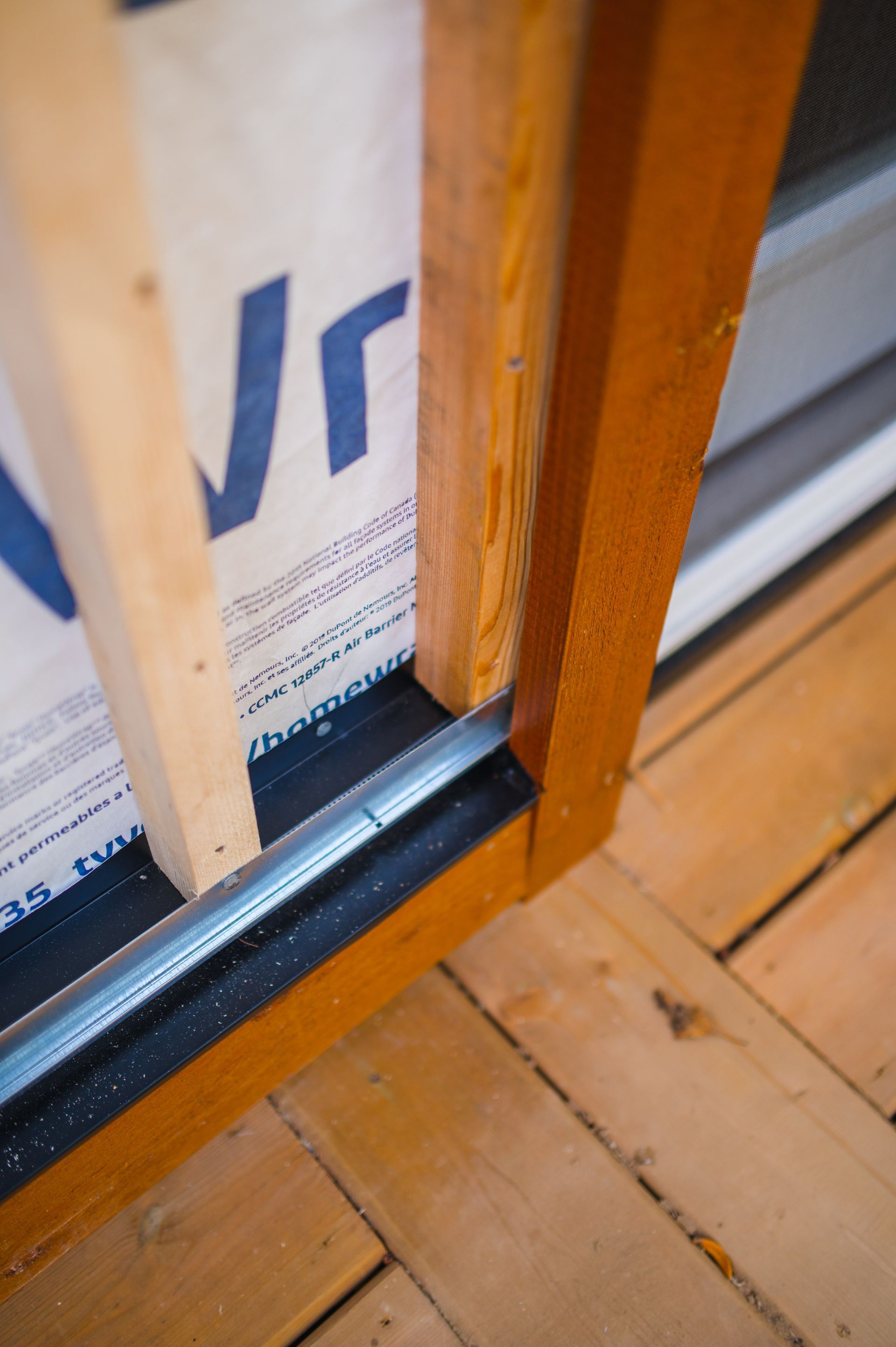 A close up of a wooden door frame on a wooden floor.