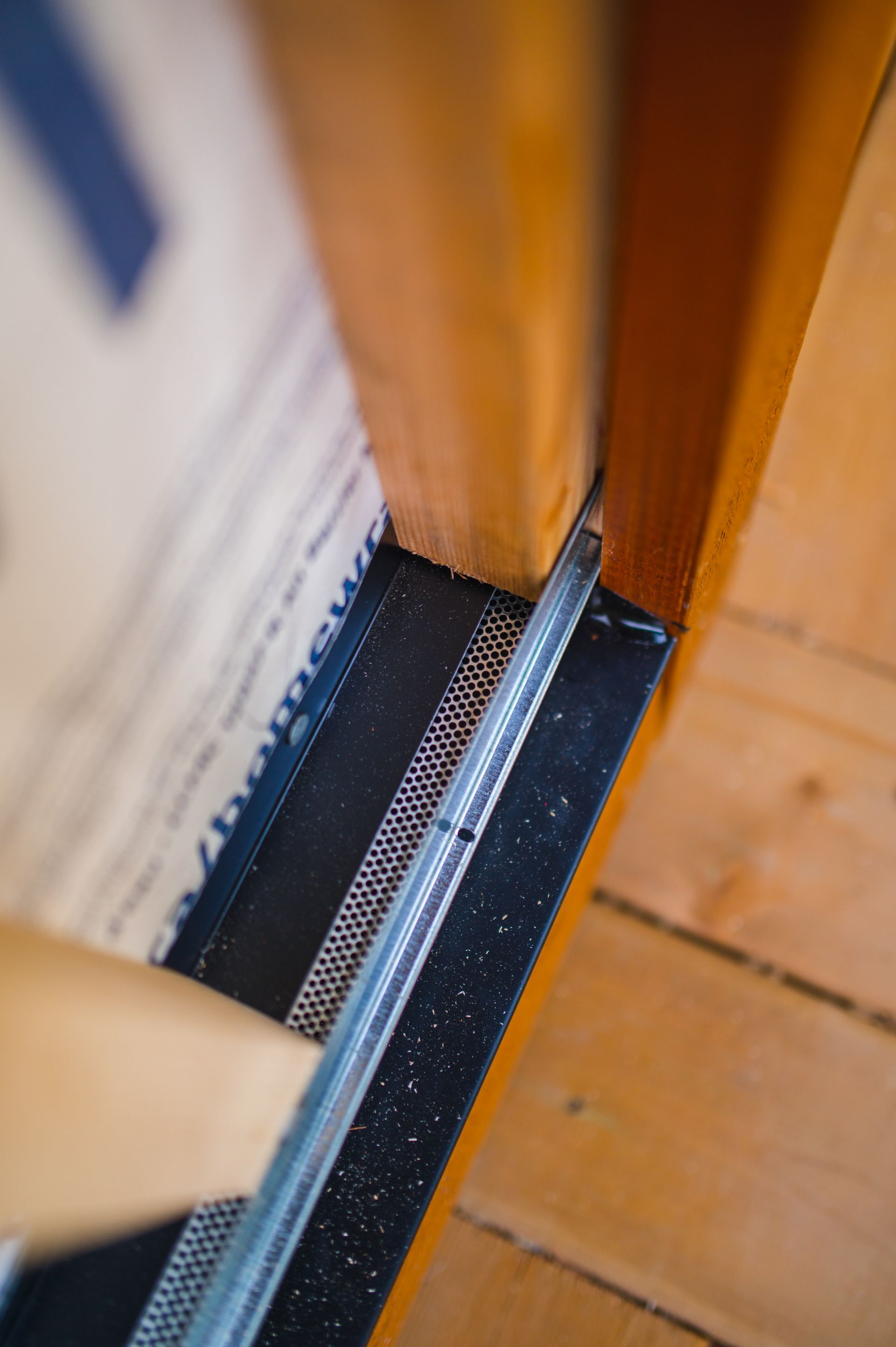 A close up of a wooden door with a metal railing.