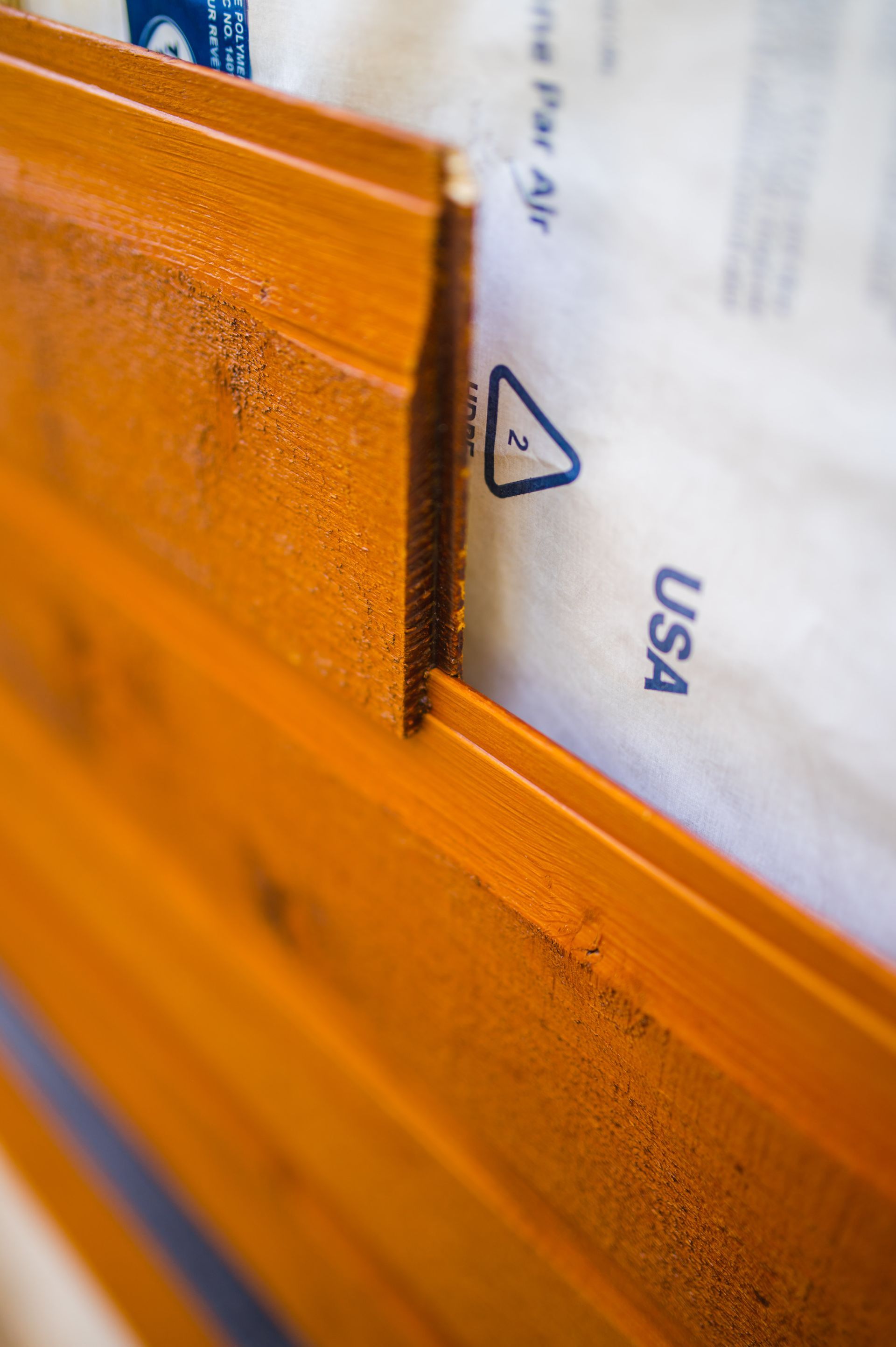 A close up of a piece of wood with a piece of plastic on it.