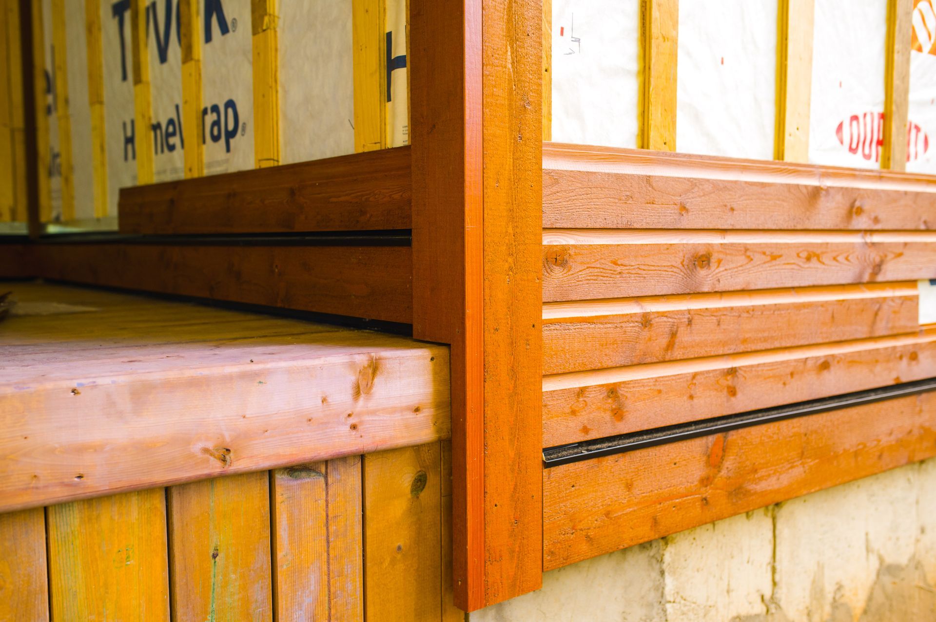 A close up of a wooden corner of a building.