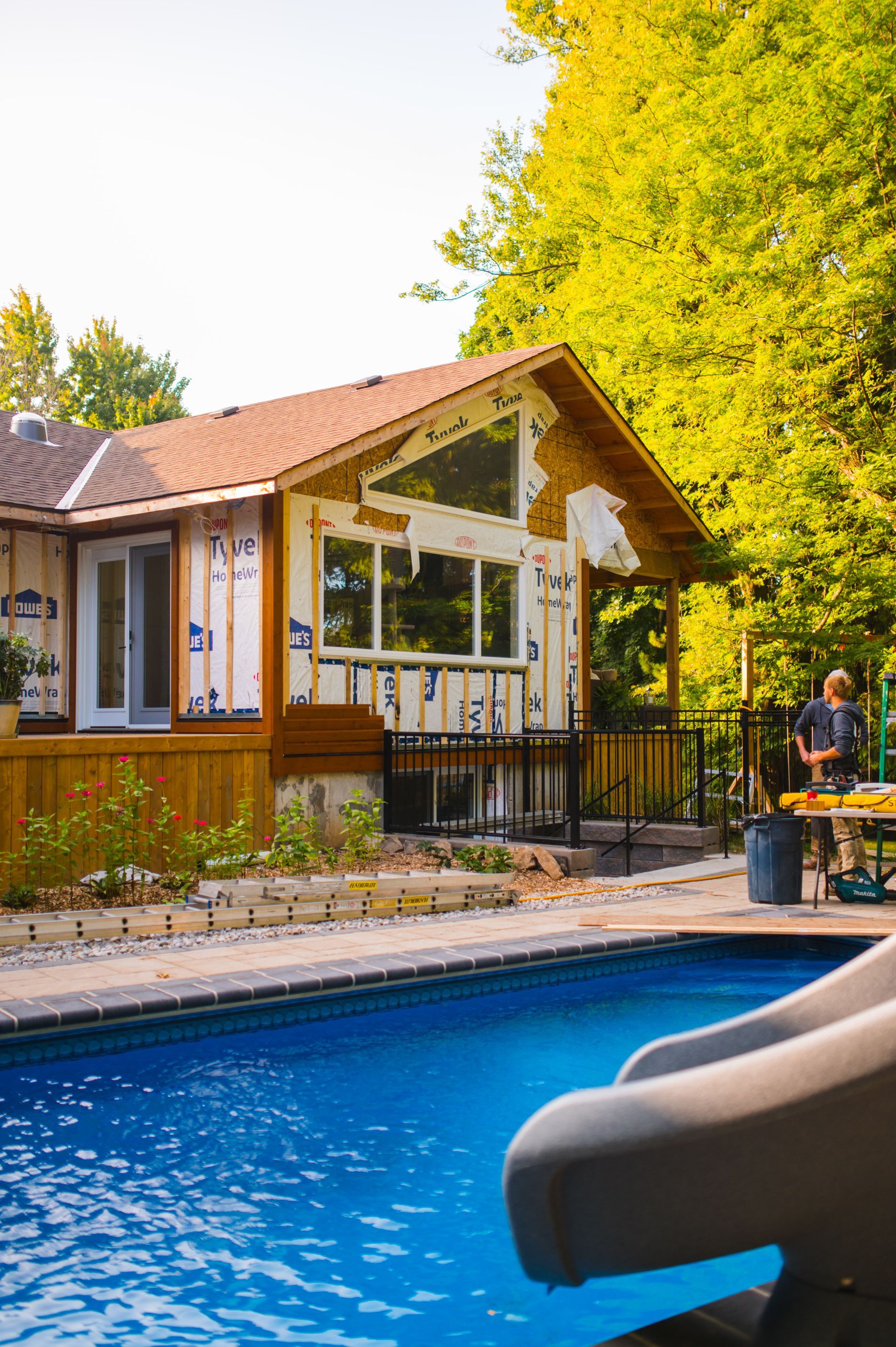 A house with a pool and a slide in front of it