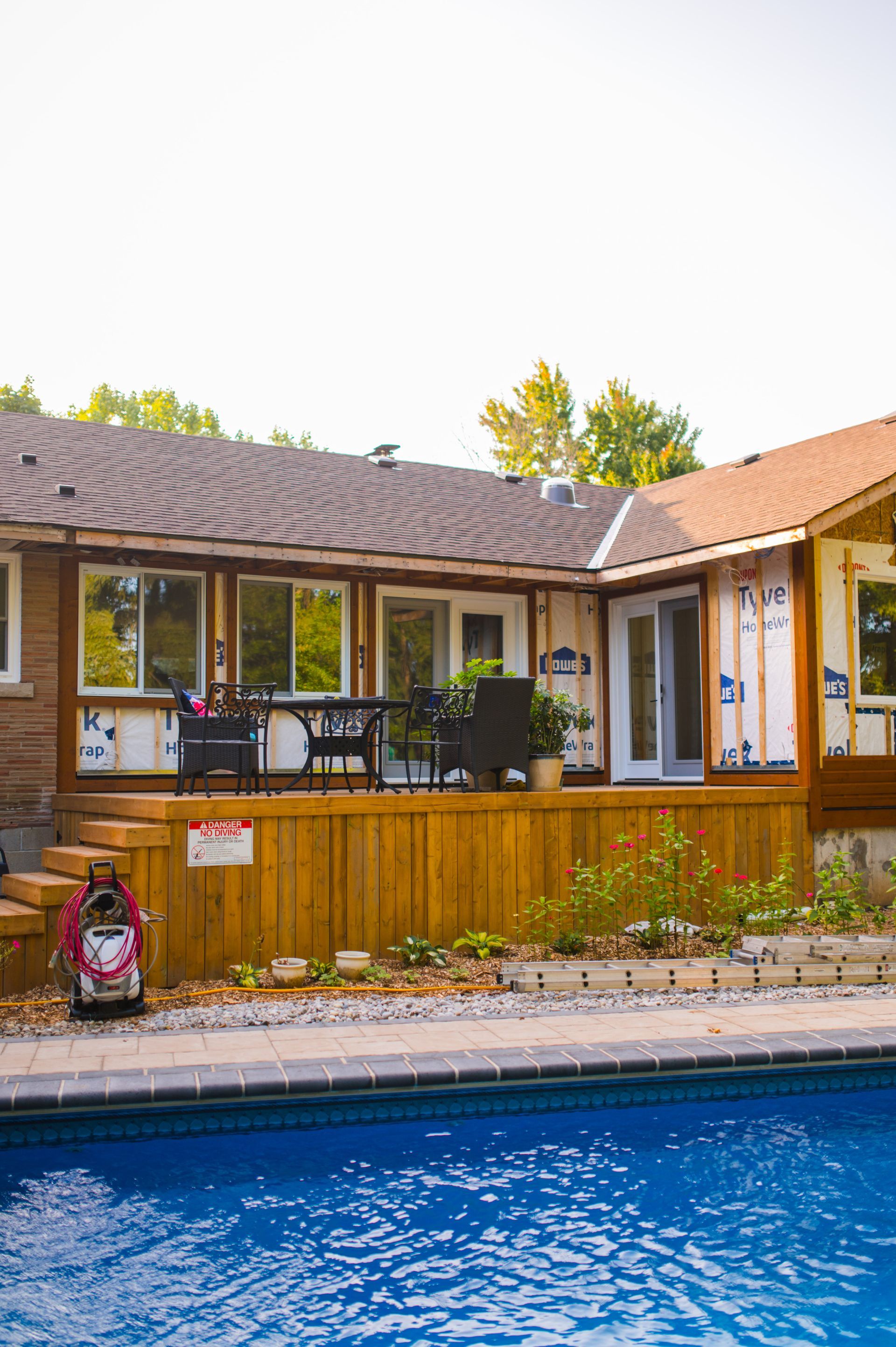 A house with a swimming pool in front of it