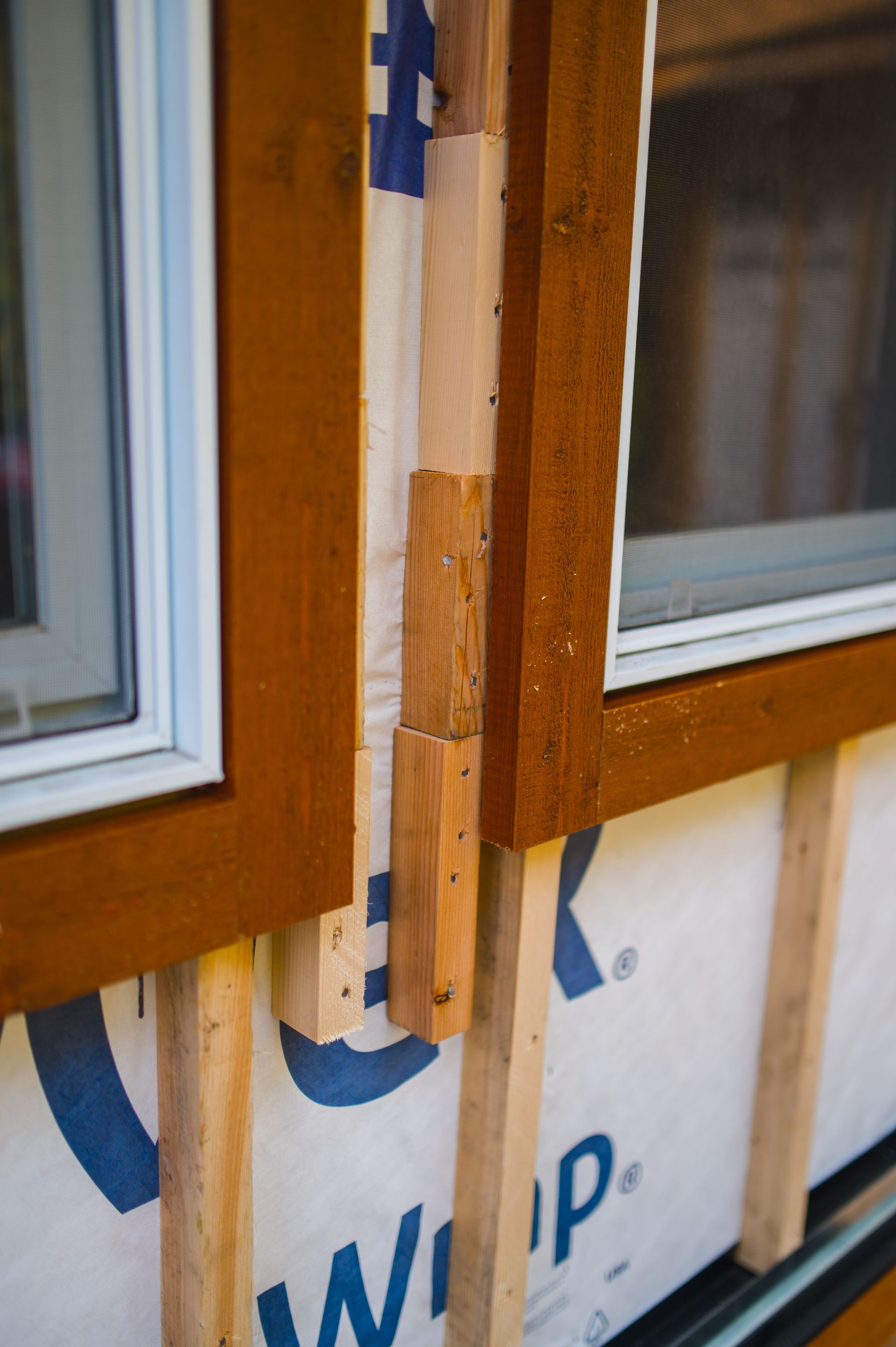 A close up of a window with a blue and white wrap on it