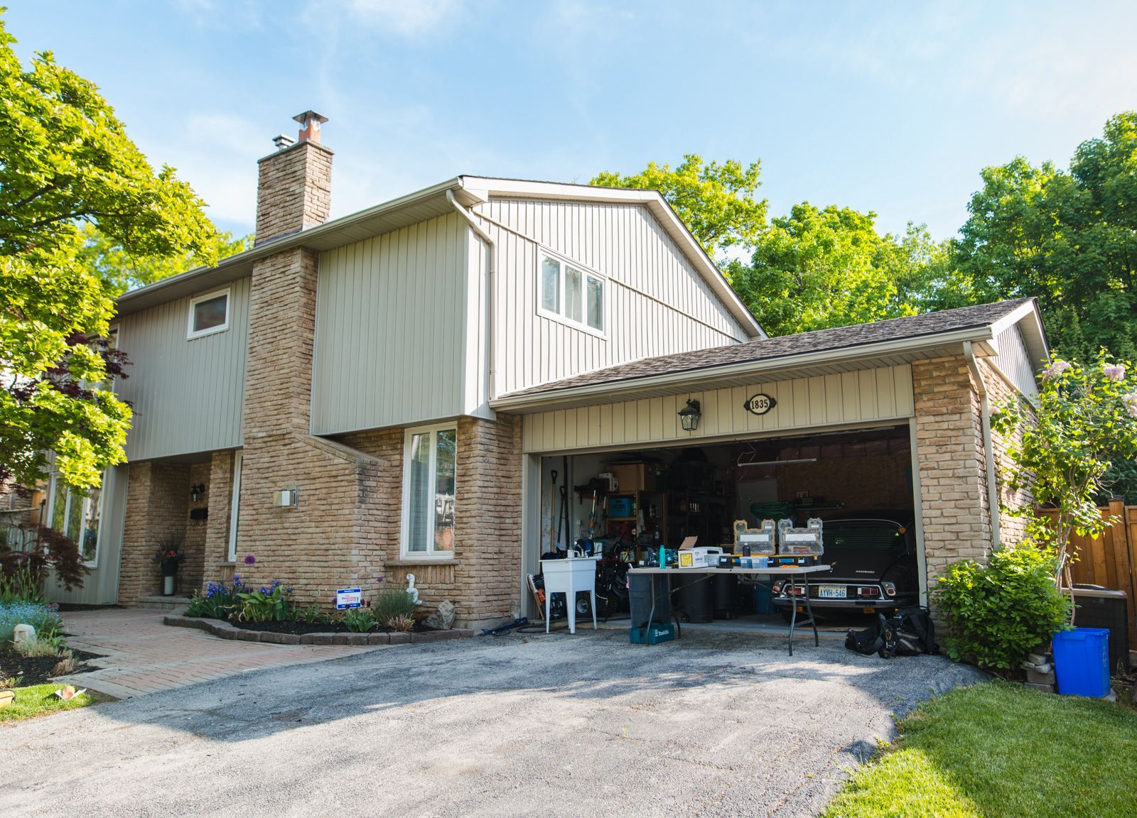 A large brick house with a garage and a driveway.