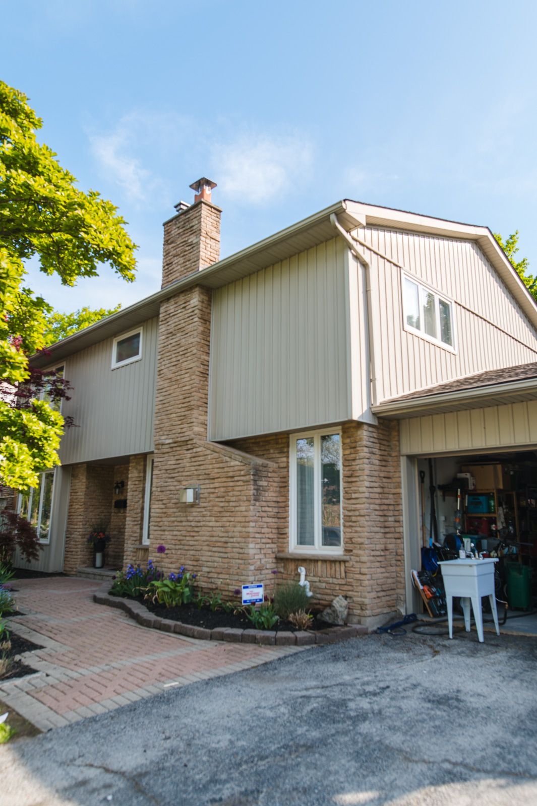 A large brick house with a garage and a driveway.