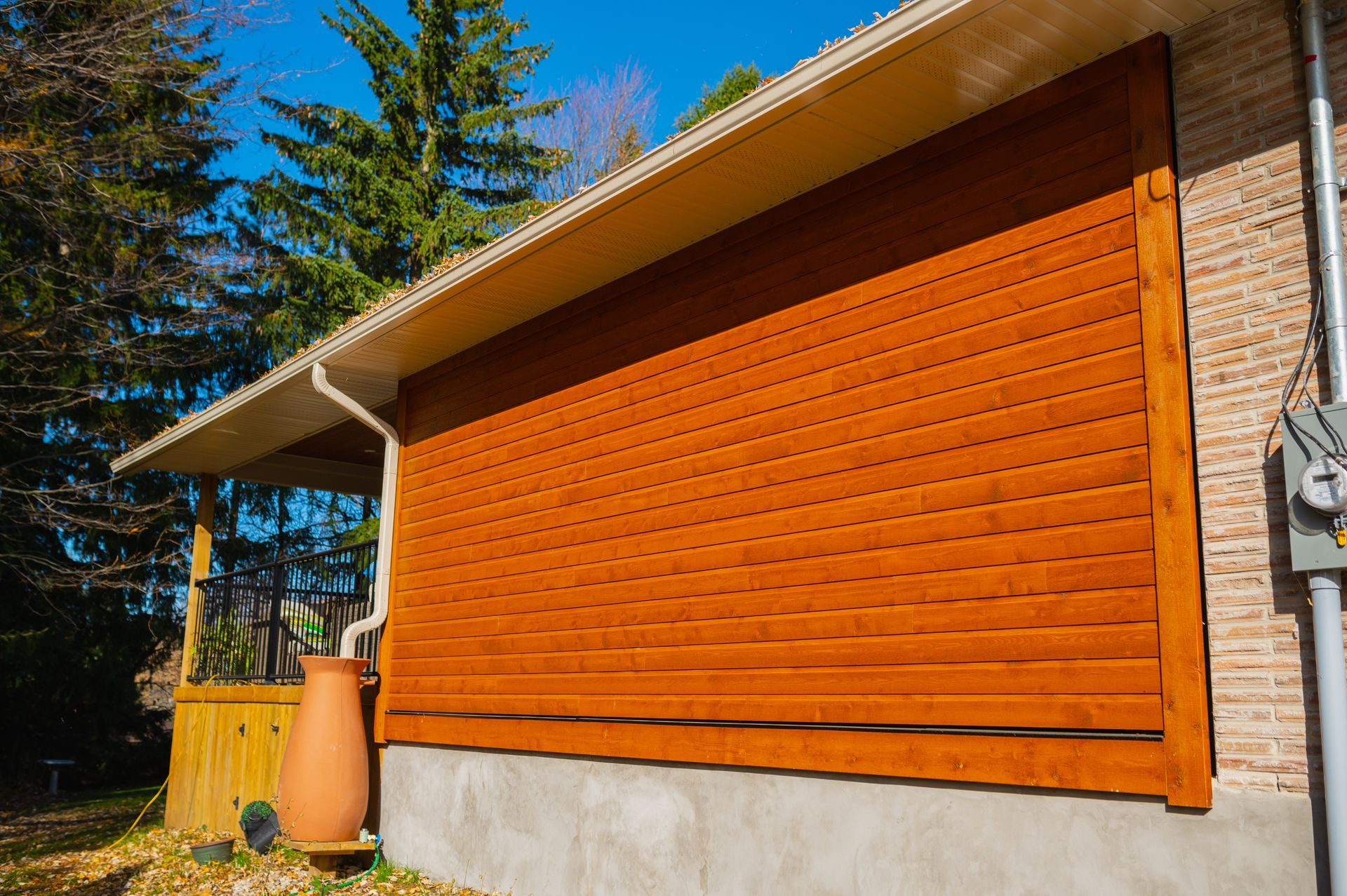 A house with a wooden shutter on the side of it.