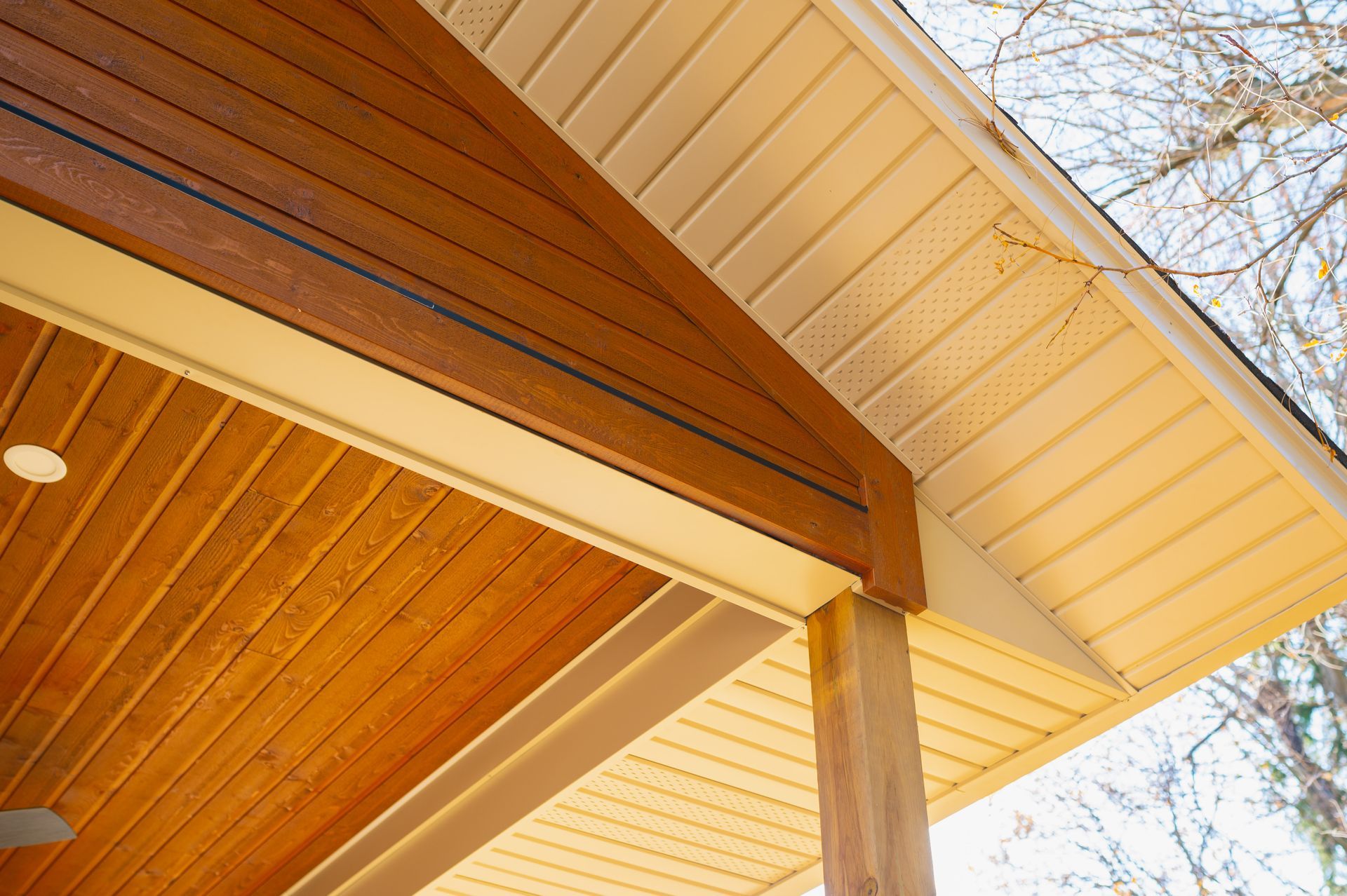 The roof of a house with a wooden ceiling and a white roof.