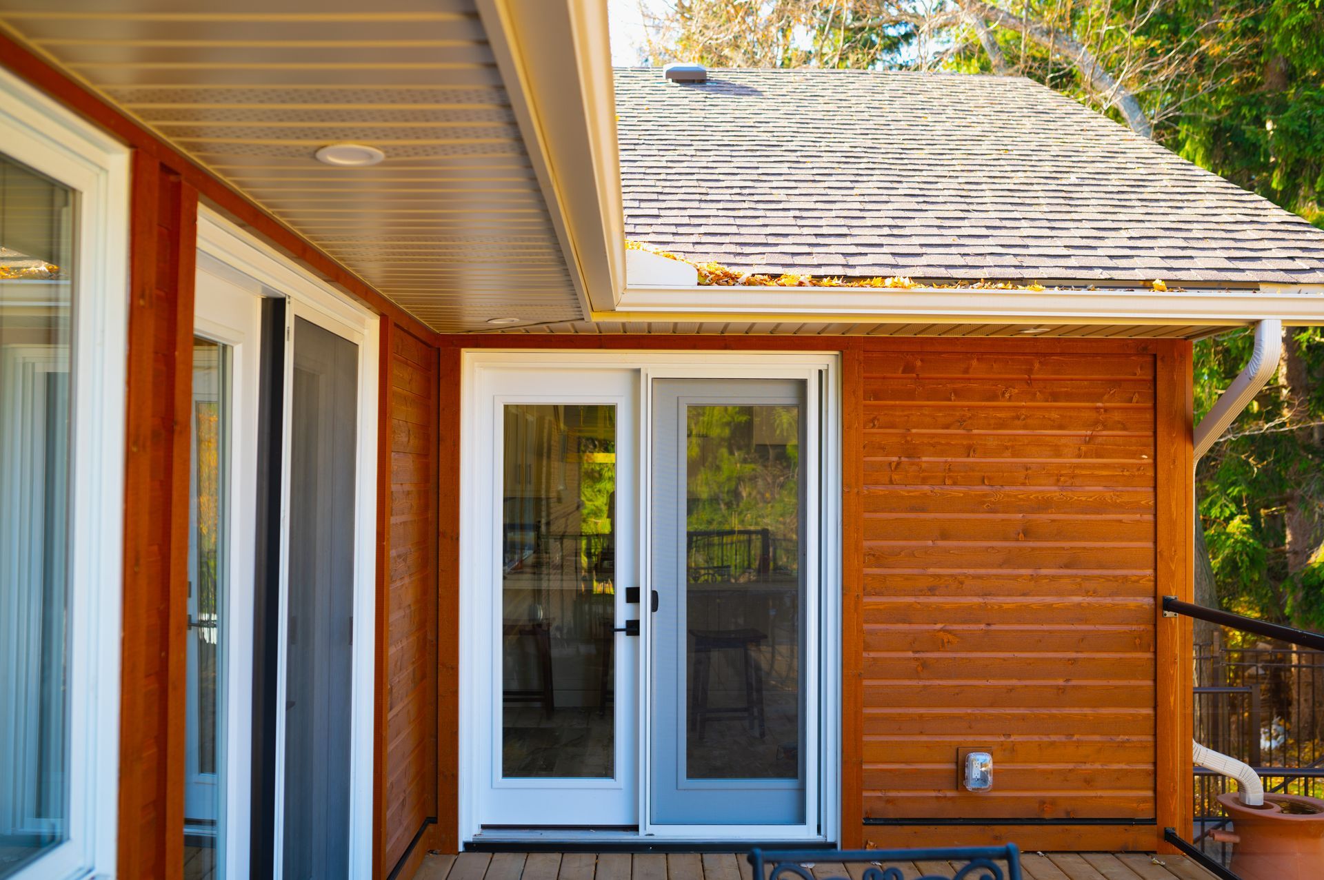 A house with a porch and a sliding glass door.