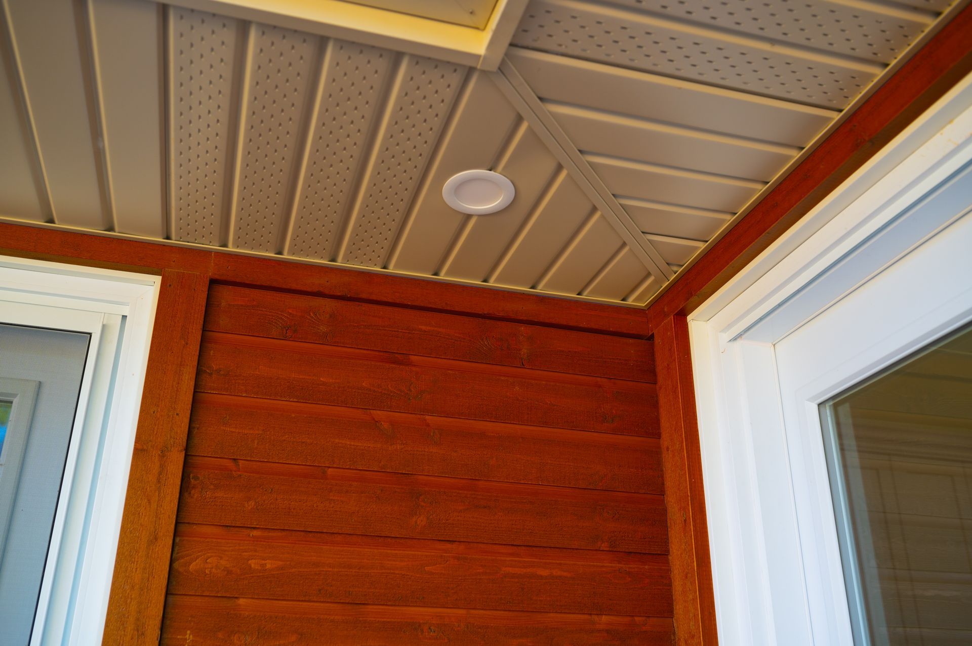 There is a light on the ceiling above the door.