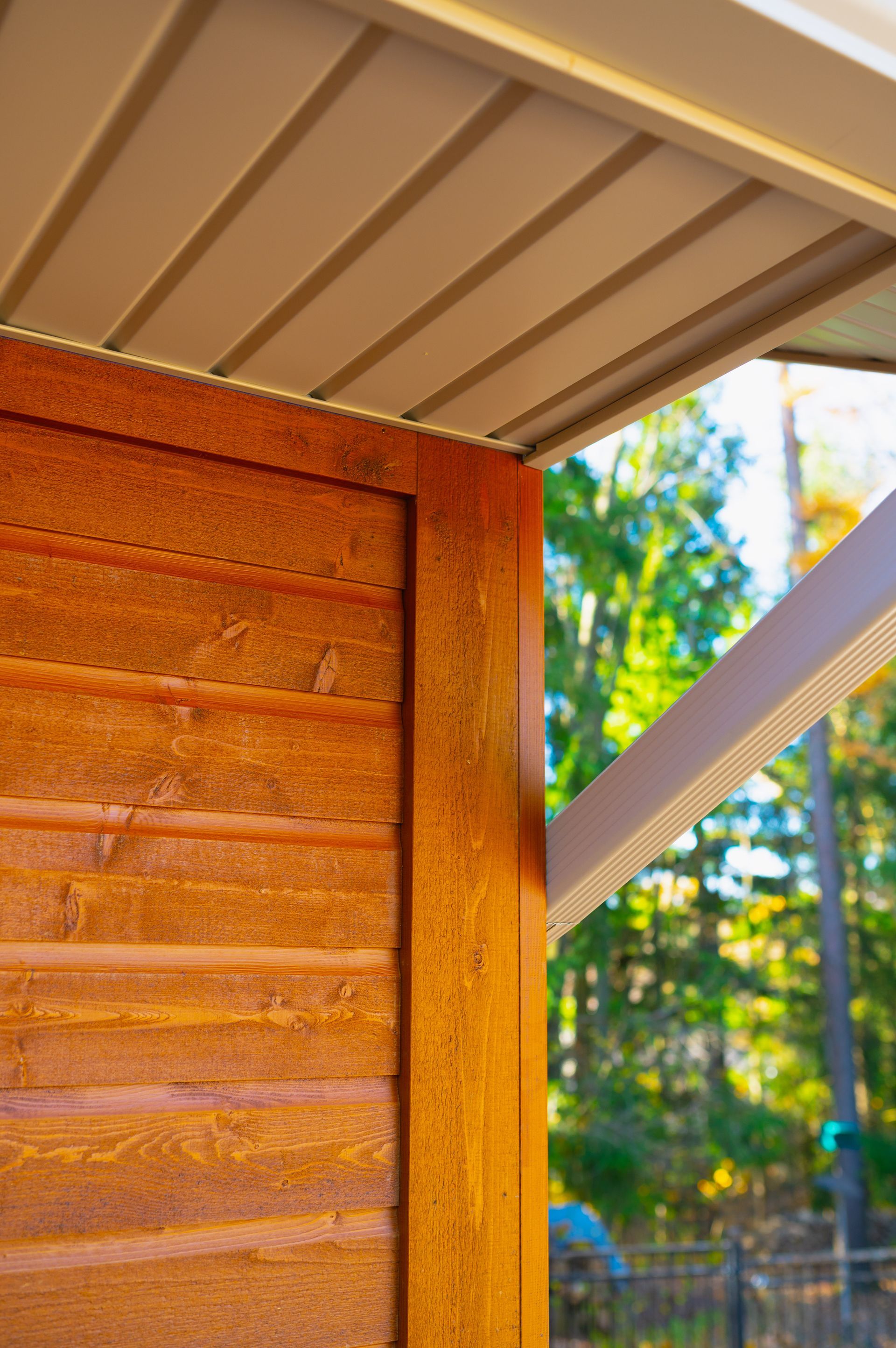 A close up of a wooden wall with a white roof.